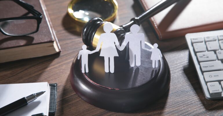 Paper cut family, judge gavel, book and other objects. Family Law